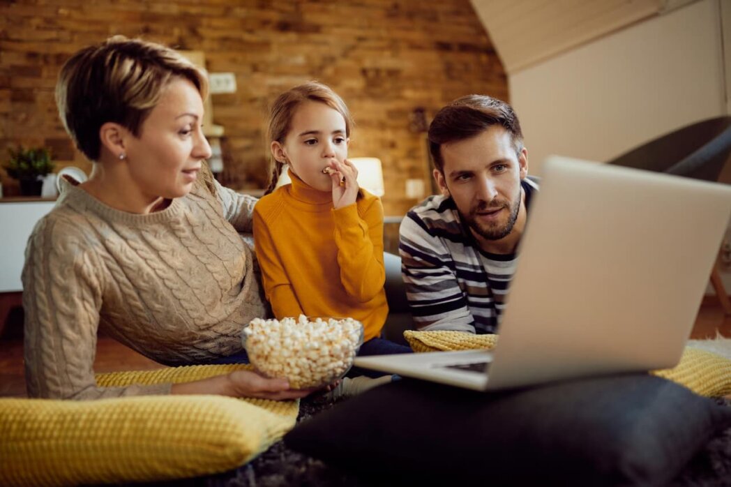 a family with a child eating popcorn