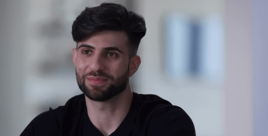 Sypherpk in black t-shirt smiling and looking forward