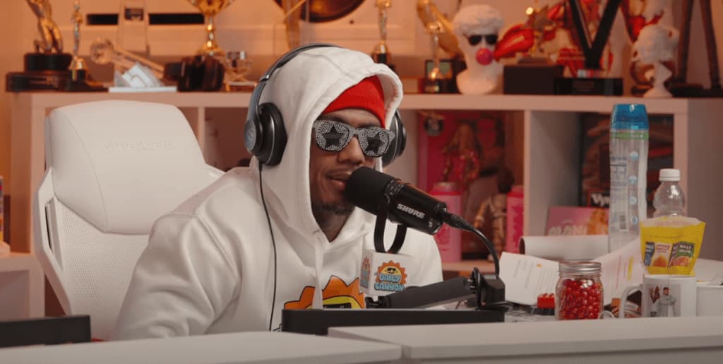 Picture of Nick Cannon in a hoodie, sunglasses, and headset