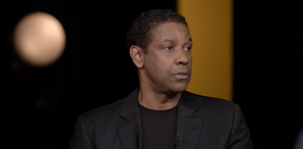 A man with a pensive expression wearing a black shirt