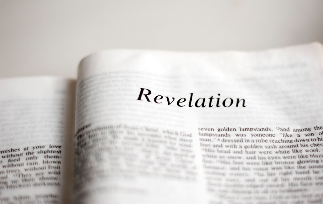 Open book page with word revelation