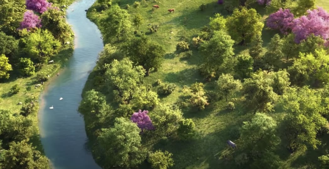 A top-down view of a field with a long lake, vibrant green trees, animals, and fresh-looking pink trees.