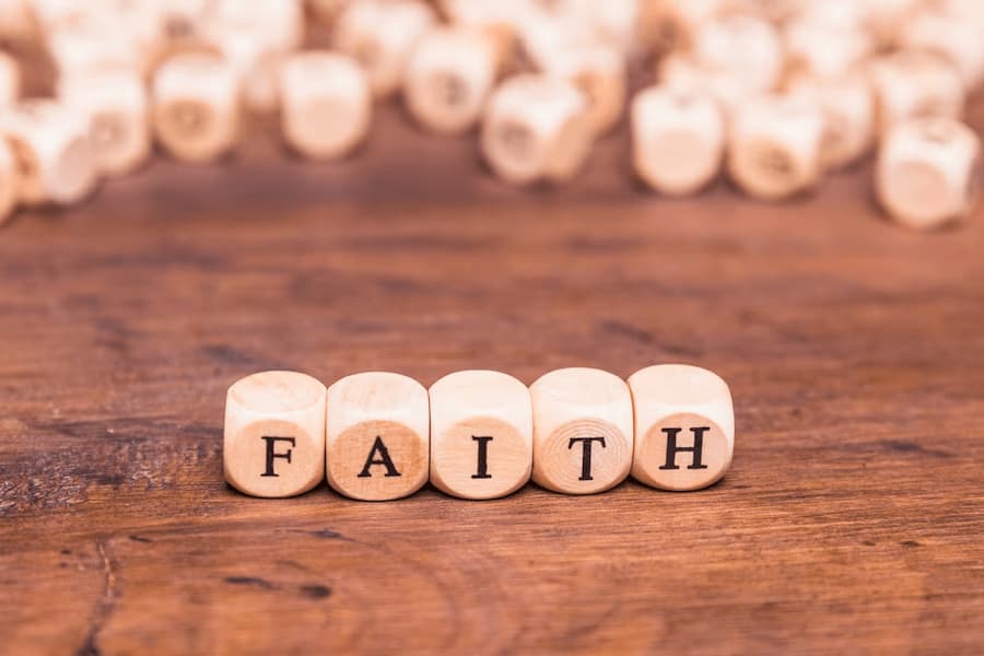 Image of wooden cubes on a table with the word 'faith