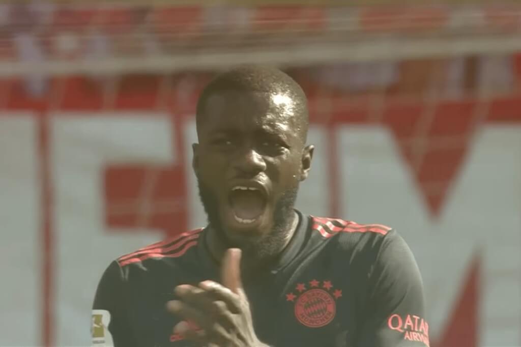 upamecano in red and black clothing looking straight with an opened mouth on the filed